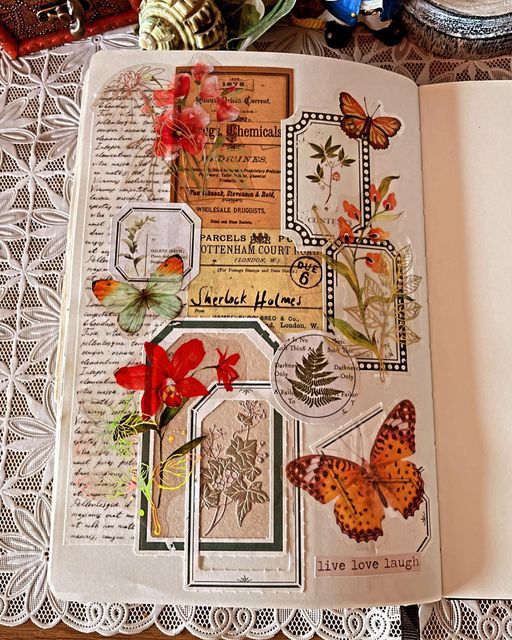 an open book with butterflies and flowers in it on a lace doily covered table