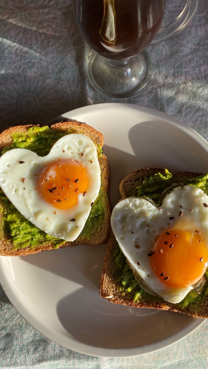 two halves of toast with an egg in the shape of a heart