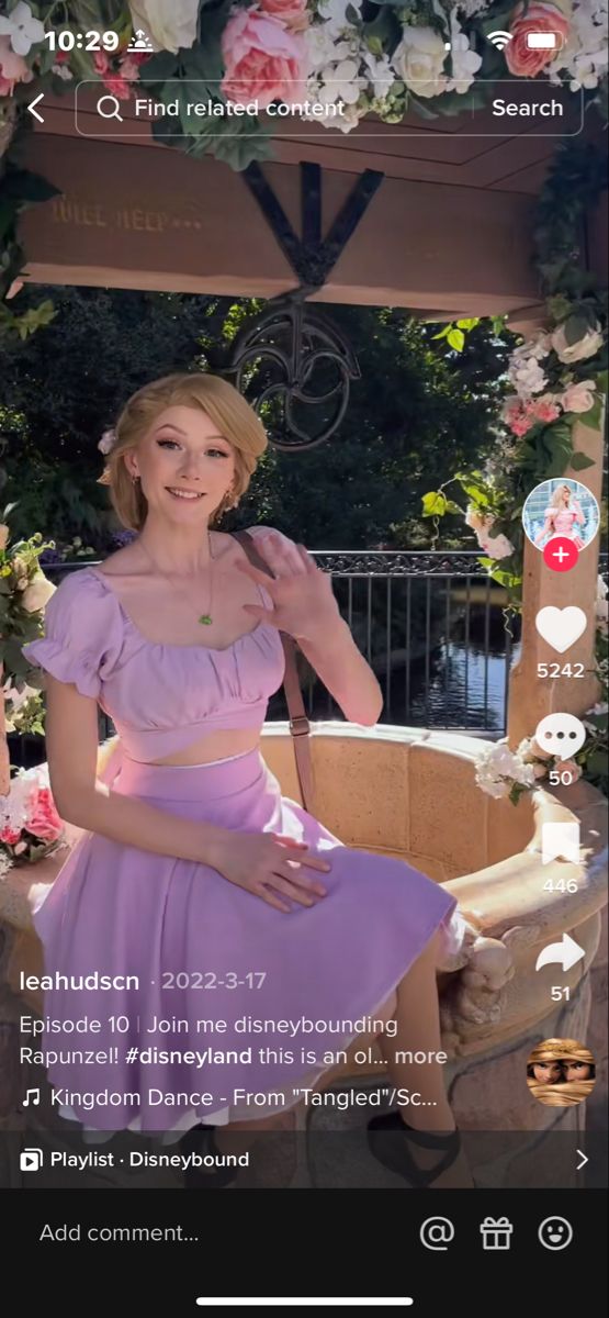 a woman in a purple dress sitting on a bench with flowers around her and the caption below