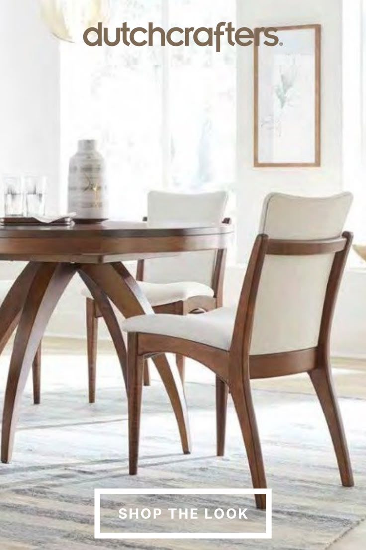 a dining room table with chairs and a rug