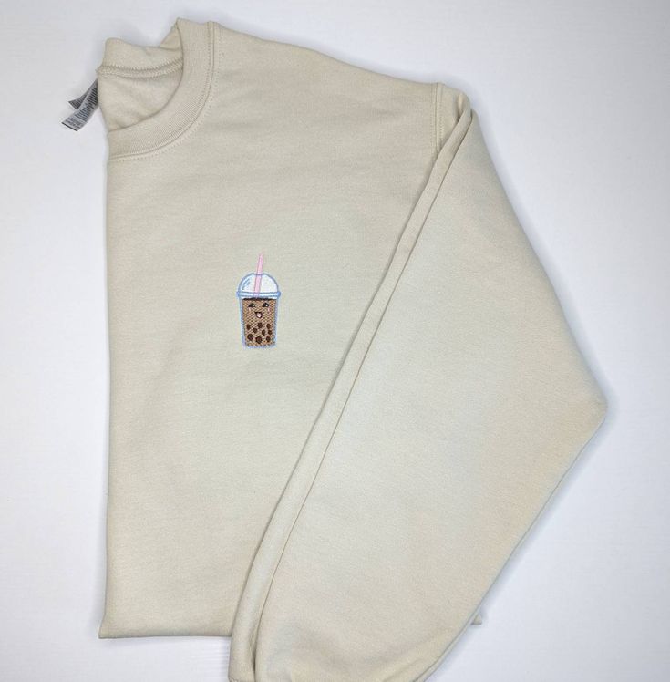 Boba Milk Tea Sweatshirt This sweatshirt is handmade and features an embroidered kawaii themed Boba Tea graphic.  Made with Gildan crewneck sweatshirts that have a soft fleece feel on the inside. Please note, this sweatshirt comes in unisex sizing. Want an oversized look? Size up when ordering! These sweatshirts are made to order. The current processing times are 3-5 business days but please message me if you need it sooner and I'll try to prioritize your order! This design is also available as Cute Cotton Sweatshirt With Embroidered Logo, Cute Crew Neck Sweater With Ribbed Cuffs, Cream Casual Tops With Embroidered Logo, Casual Cream Tops With Embroidered Logo, Cute Cotton Sweatshirt For Everyday, Cute Everyday Cotton Sweatshirt, Cute Cotton Everyday Sweatshirt, Casual Cream Crew Sweatshirt, Casual Embroidered Sweater For Loungewear