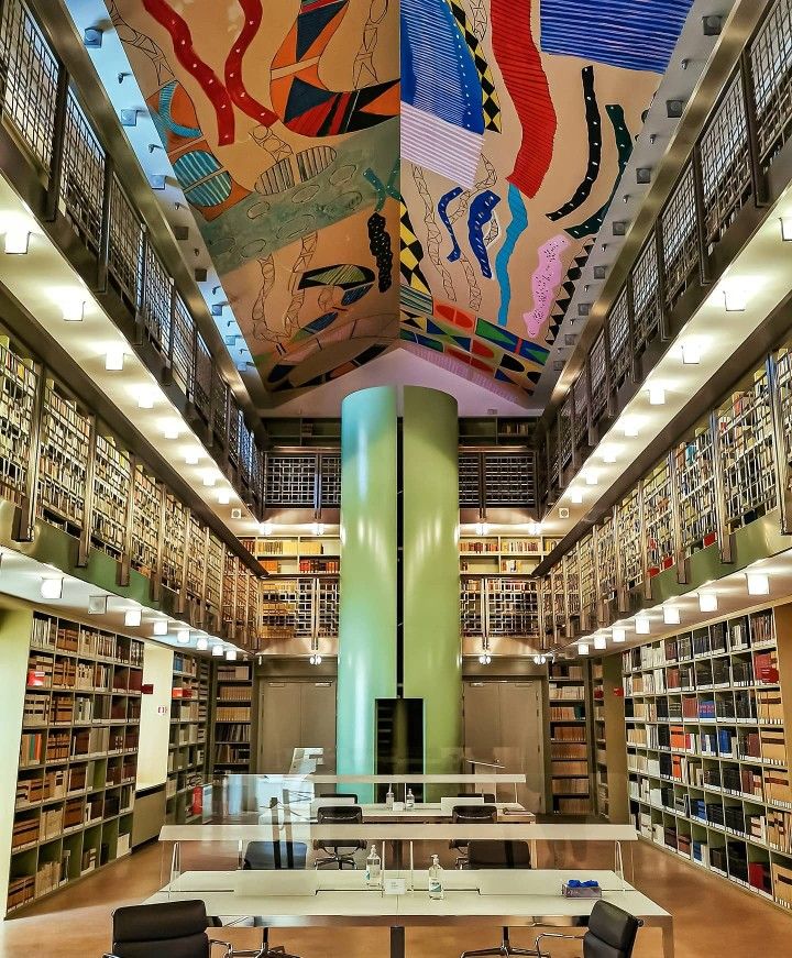 a library with tables and chairs in it