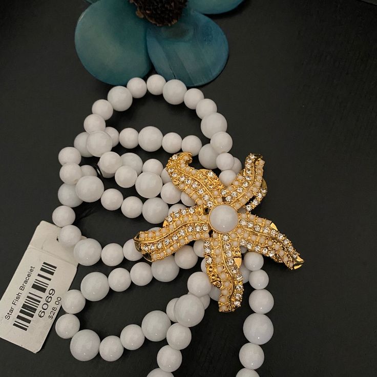 Traci Lynn Jewelry Summer Starfish Bracelet White Star-shaped Jewelry With Starfish Charm, White Starfish Beach Jewelry, Elegant Starfish Bracelet For Gift, Elegant Starfish Bracelets For Beach, Adjustable White Necklace With Starfish Charm, White Adjustable Necklace With Starfish Charm, Adjustable White Starfish Necklace, White Adjustable Starfish Necklace, Adjustable White Jewelry With Starfish Charm