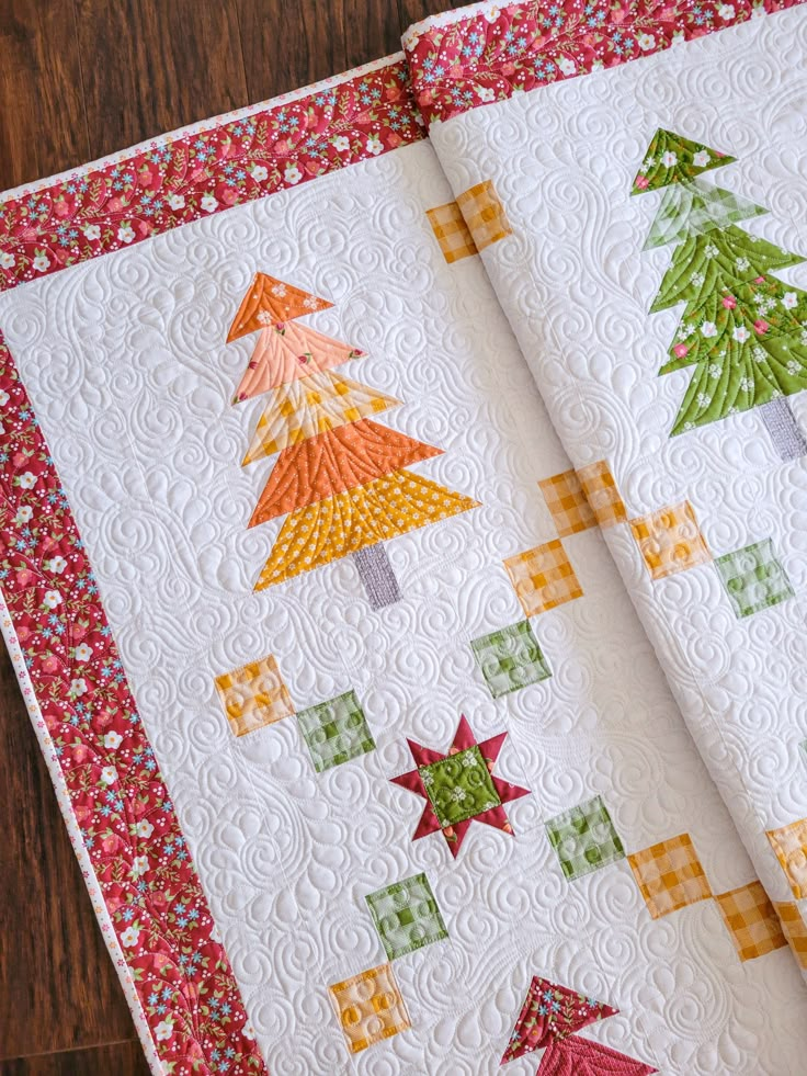 two quilts with christmas trees on them