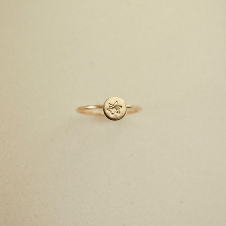 Embrace timeless elegance with our Birth Flower Ring, where traditional charm meets personalized flair. Crafted in 14k gold filled, this meaningful piece can be tailored with a hand-stamped birth flower. Carry a token of cherished memories with you wherever you wander, securely encircling your finger. Handcrafted in the U.S.A Details Hypoallergenic, Water Resistant, Tarnish-free Material : 14k Gold Filled Flower Stamp 4mm Note: If your size is a half ex: 5 1/2, leave us a note at the cart reques 40th Gifts, 20 Gifts, Flower Stamp, 30 Gifts, Beaded Cuff, Birth Flower, Birth Flowers, Chain Choker, Cherished Memories