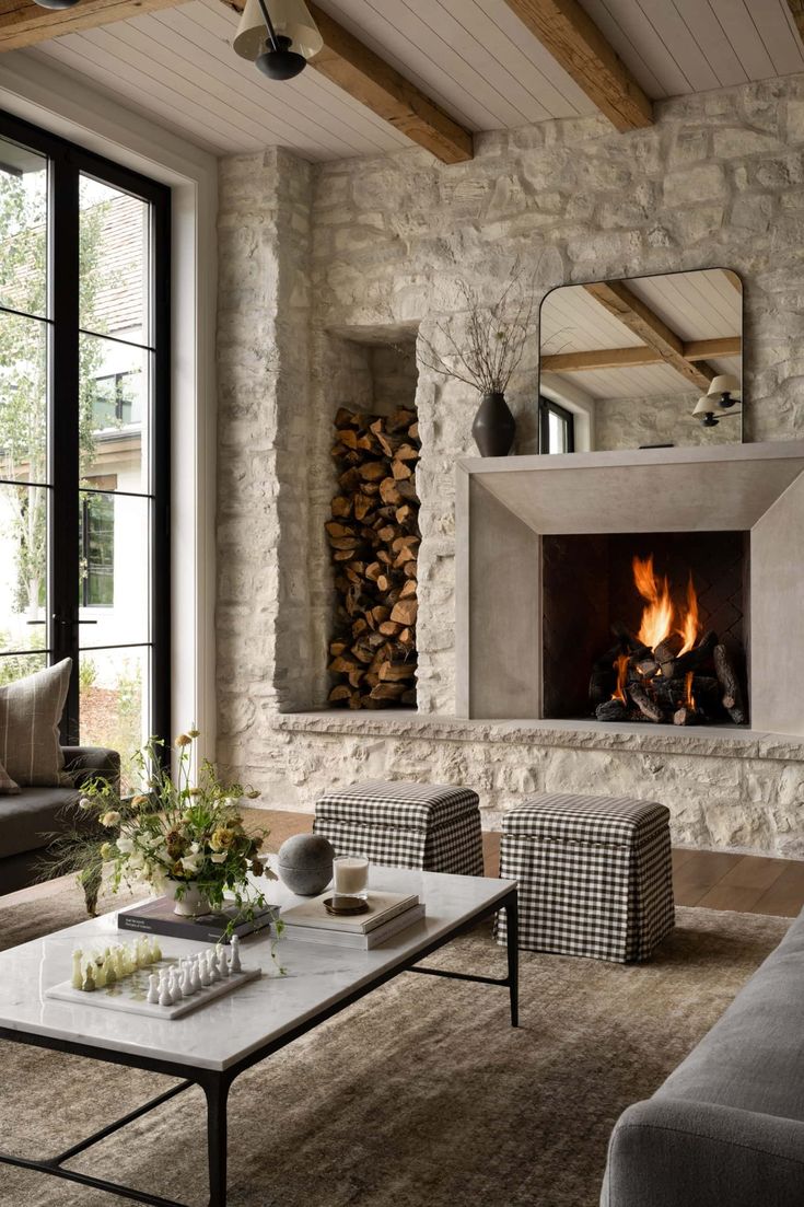 a living room filled with furniture and a fire place in the middle of it's wall