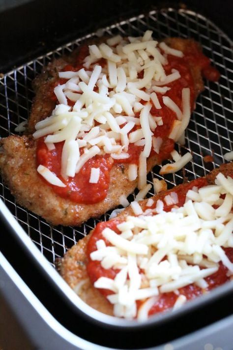 three pizzas covered in cheese and sauce on top of an oven rack with grated cheese