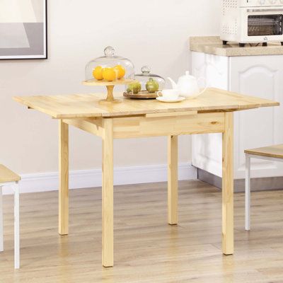 a wooden table with two chairs around it in a kitchen next to a microwave oven