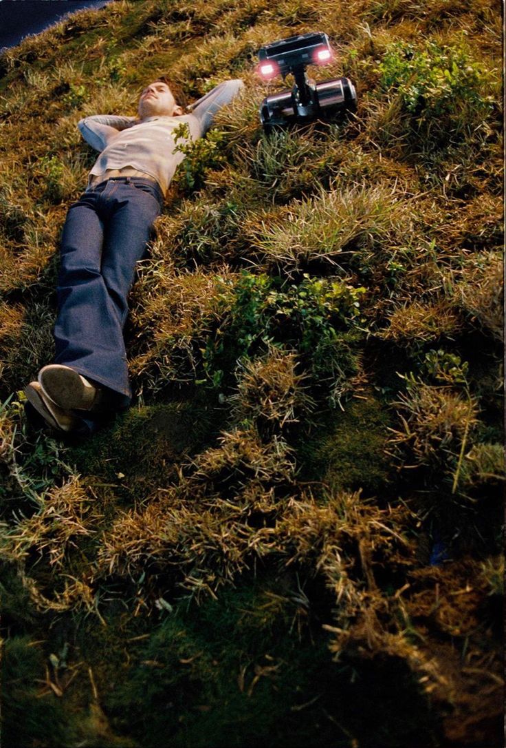 a man laying on the ground with his head down and arms out in front of him