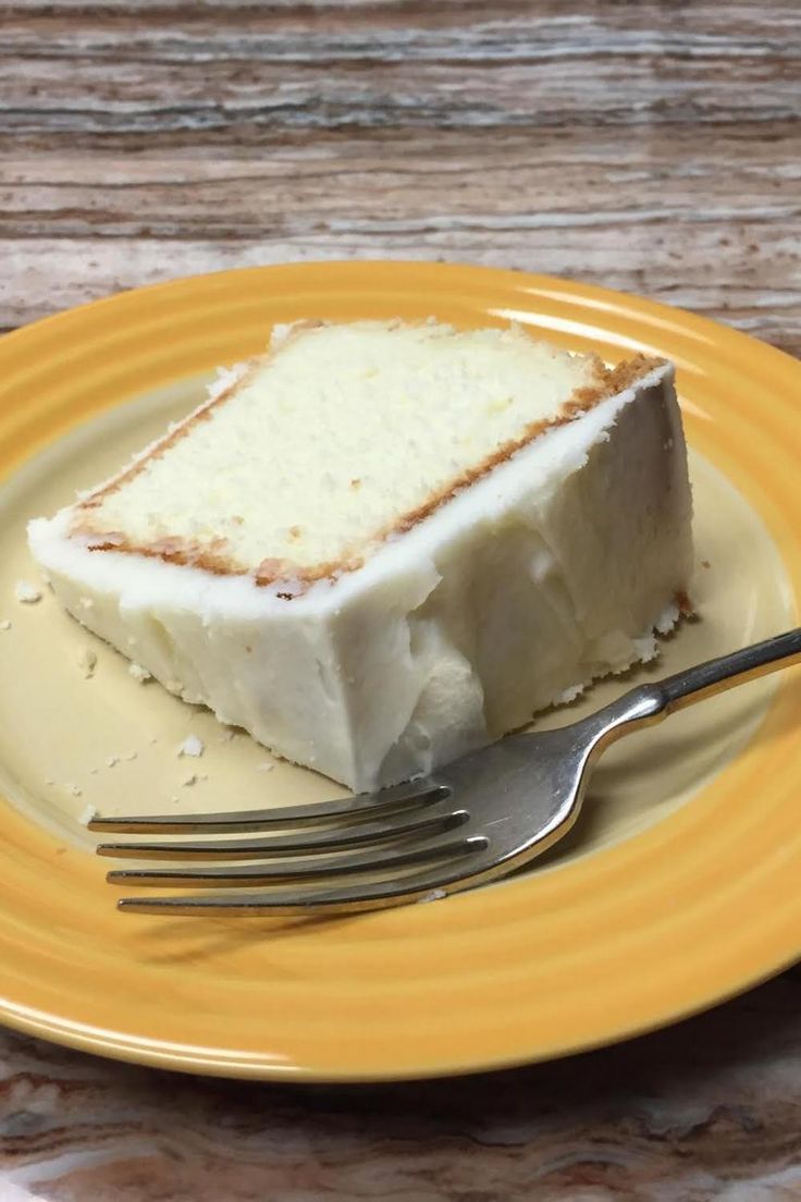 a piece of cake sitting on top of a yellow plate with a fork next to it