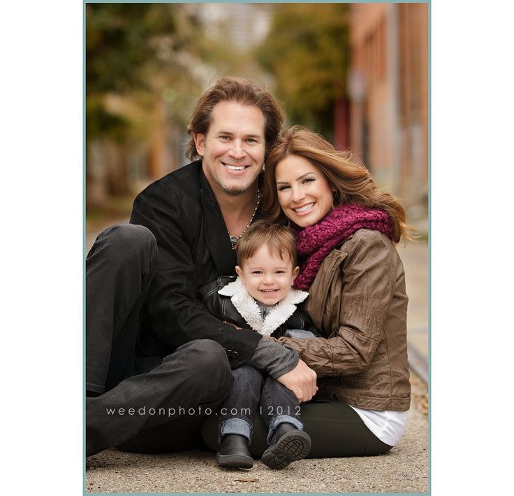 a couple and their child are posing for pictures