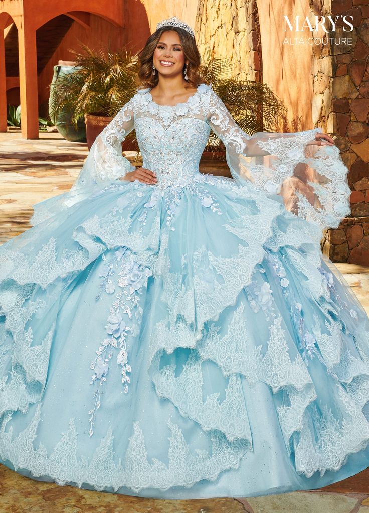 Look breathtaking in this ruffled long bell sleeve dress with A-line skirt by Mary's Bridal Alta Couture MQ3088. This glitter tulle quinceanera ball gown features a strapless sweetheart neck line, detachable shrug with scoop neck line and bell sleeves, ruffles on skirt, lace applique, embroidery, 3D flowers, beading, lace-up back closure, and sweep train. Mary's Bridal Alta Couture Collection: Fall 2022 Style Number: MQ3088 Fabric: Tulle, Glitter Tulle, Applique, 3D Flowers, Beading Colors: Lila Sweet 15 Dresses Quinceanera Light Blue, Sweet 15 Dresses Quinceanera, Tulle Applique, Quinceñera Dresses, Mary's Bridal, Debutante Ball, Embroidery 3d, Quinceanera Dresses Blue, 2022 Style