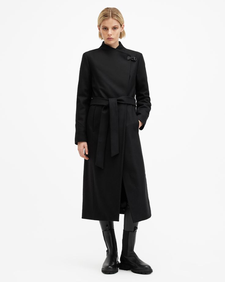 This coat is designed to a regular fit that is true to size Button and clasp lock closure Long sleeves Below knee length Funnel neck Self-tie belt Two pockets One interior pocket Recycled fabrics Italian cloth – woven in Prato, Italy. Luxury Belted Wool Coat For Formal Occasions, Formal Wool Coat With Belted Cuffs, Elegant Formal Wool Coat With Belted Cuffs, Allsaints Black Outerwear For Work, Classic Formal Wool Coat With Self Belt, Elegant Allsaints Outerwear For Work, Formal Long Coat With Self Belt, Elegant Business Outerwear With Belted Cuffs, Chic Allsaints Winter Outerwear