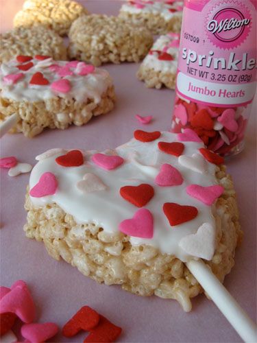 rice krispy treats are decorated with hearts and lollipops