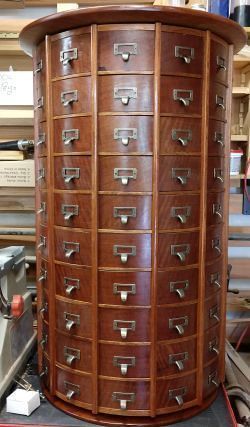 a large wooden cabinet with many drawers