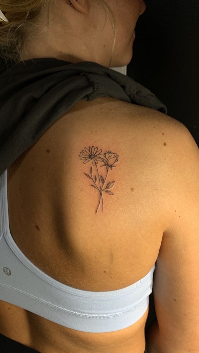 a woman with a flower tattoo on her back