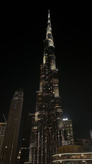 the burj building is lit up at night in new york city, ny