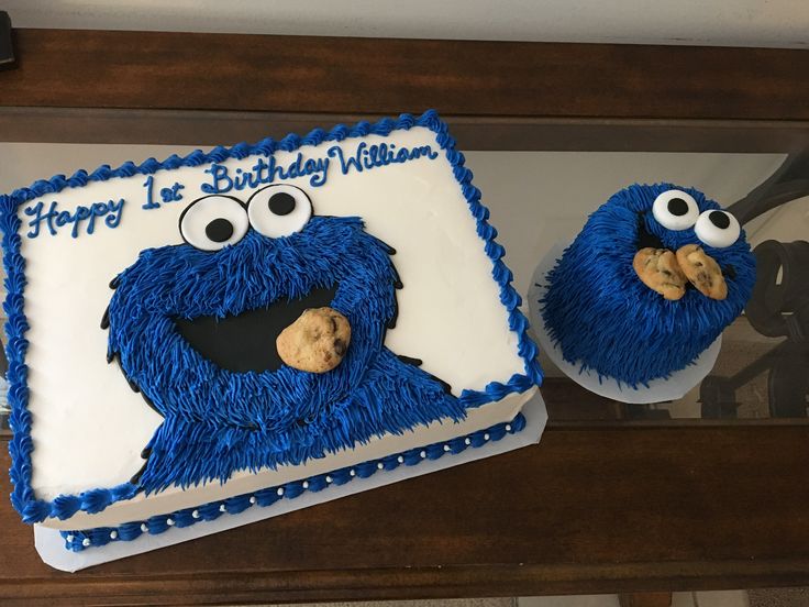 two birthday cakes decorated to look like sesame street characters, one is blue and the other is white