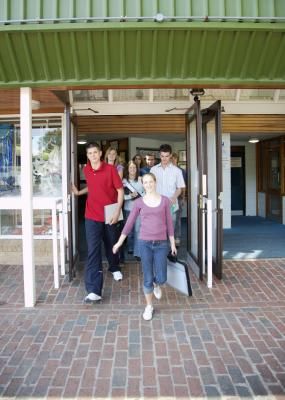 a group of people standing in front of an open door