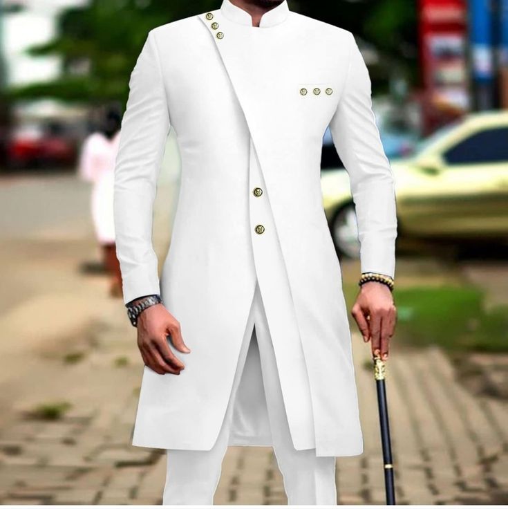 a man in a white suit holding an umbrella