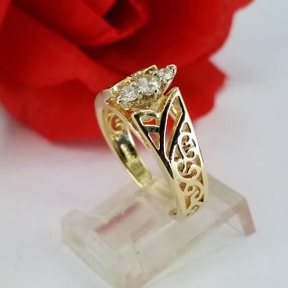 Beautiful engagement ring in 14k gold with three round synthetic zircon stones. Such a beautiful ring for only $379.00. Ring size is adjustable, please note the size in the personalization section of checkout. Hermoso anillo de compromiso en oro de 14k con tres piedras redondas circonias sintéticas. Un anillo tan hermoso por solo $379.00. El tamaño del anillo es ajustable, porfavor anote el tamaño en la sección de personalización en la compra. Elegant Gold Engraved Ring With Diamond Accents, Elegant Yellow Gold Engraved Ring With Diamond Accents, Elegant Engraved Yellow Gold Ring With Diamond Accents, Gold Three Stone Princess Cut Diamond Ring, Gold Princess Cut Diamond Ring With Three Stones, Yellow Gold Three Stone Diamond Ring For Promise, Gold Princess Cut Three Stone Diamond Ring, Formal Yellow Gold Three Stone Rings, Elegant Three Stone Birthstone Ring In 14k Gold