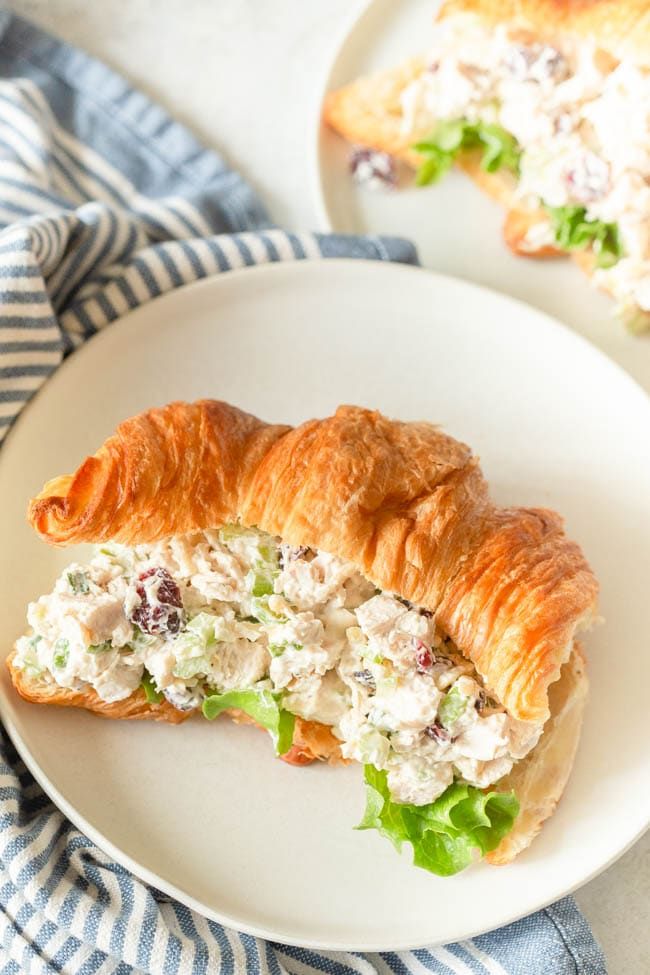 there is a croissant with chicken salad on it