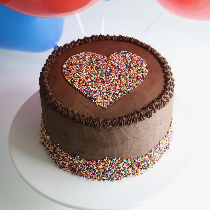 a chocolate cake with sprinkles and a heart on top