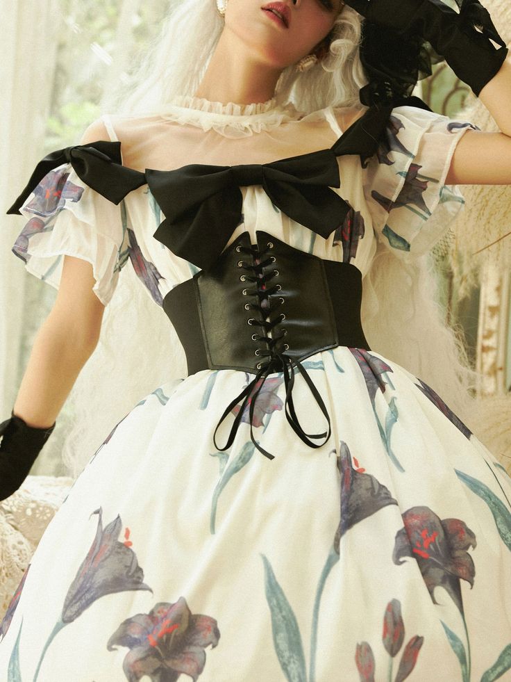 A corset dress with a black lily design that exudes a mysterious atmosphere. An item that expresses mad love. The shoulders and chest are decorated with jet black ribbons. Elegant fluffy and voluminous hem. Please wear it with the included corset. 
 
 
 Size 
 
 
 
 
 S size 
 
 Length: 120cm 
 Shoulder width: 35cm 
 Bust: 88-95cm 
 
 M size 
 
 Length: 122cm 
 Shoulder width: 37.5cm 
 Bust: 96-103cm 
 
 L size 
 
 Length: 124cm 
 Shoulder width: 40cm 
 Bust: 104-111cm 
 
 
 
 
 
 
 
 Material Elegant Black Corset Belt With Boned Bodice, Gothic Overbust Corset Belt For Party, Black Sleeveless Corset For Costume, Black Overbust Corset Dress For Costume Party, Halloween Overbust Corset Dress With Attached Cancan, Black Corset Dress With Boned Bodice And Sweetheart Neckline, Elegant Black Corset Belt For Costume, Black Corset Dress With Cancan For Costume Party, Overbust Dress With Corset Back For Fancy Dress