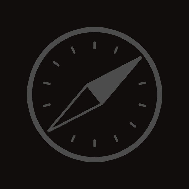 a black and gray clock with an arrow pointing to the left side on a dark background