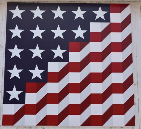 an american flag painted on the side of a building with stars and stripes in red white and blue