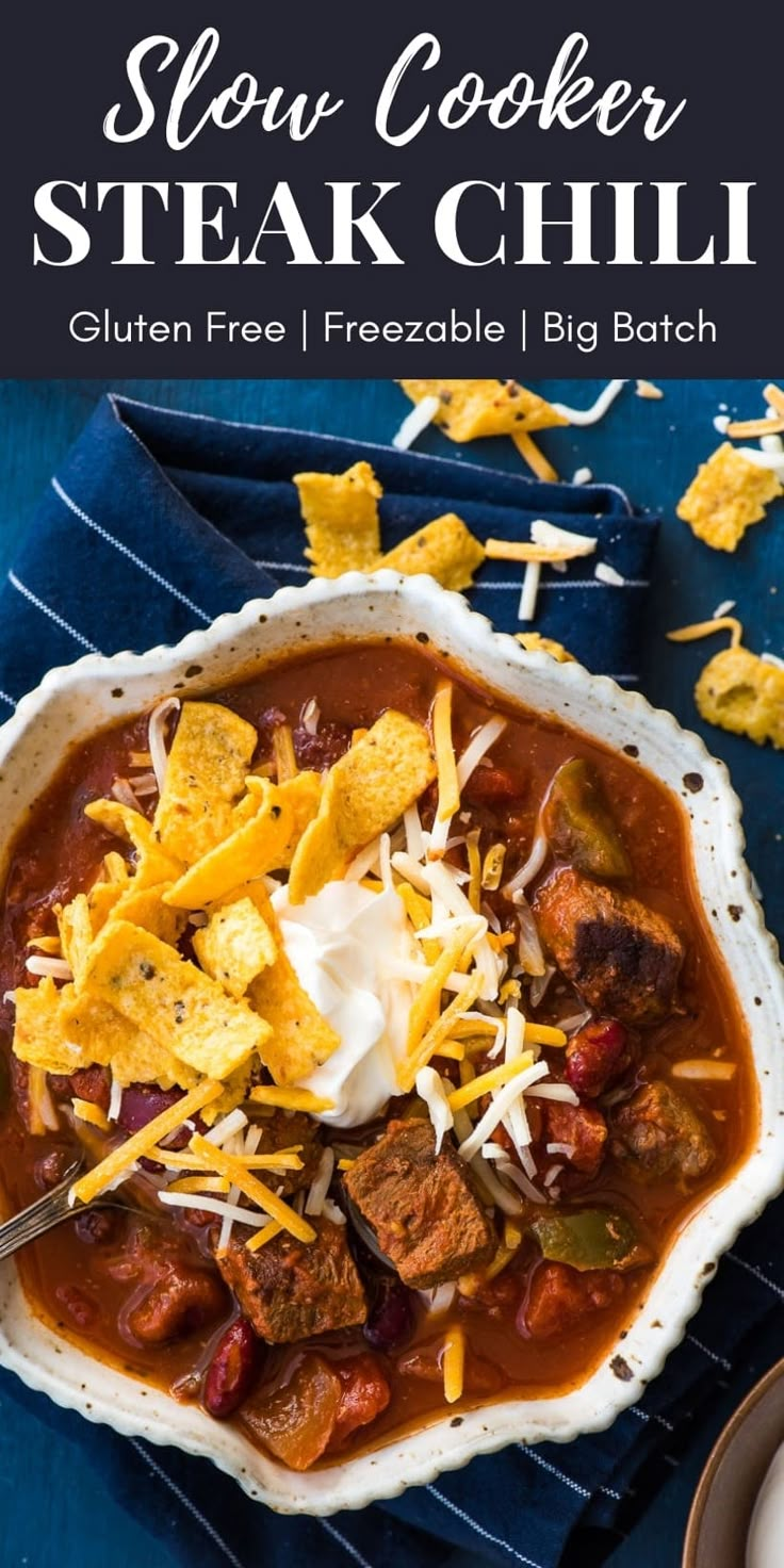 slow cooker steak chili in a bowl with tortilla chips on the side