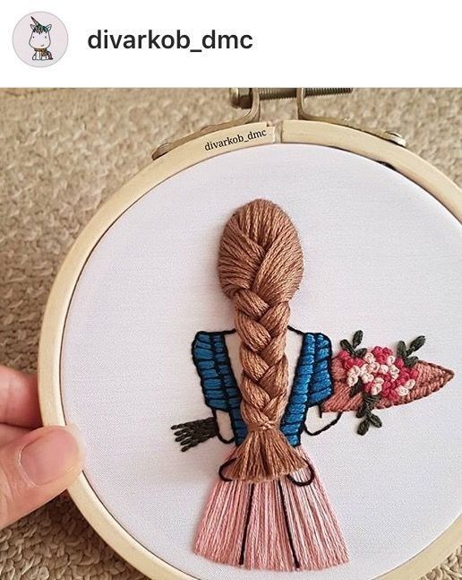 someone is holding up a hand embroidered picture