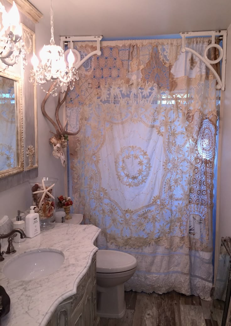 a bathroom with a sink, toilet and shower curtain in it's center area