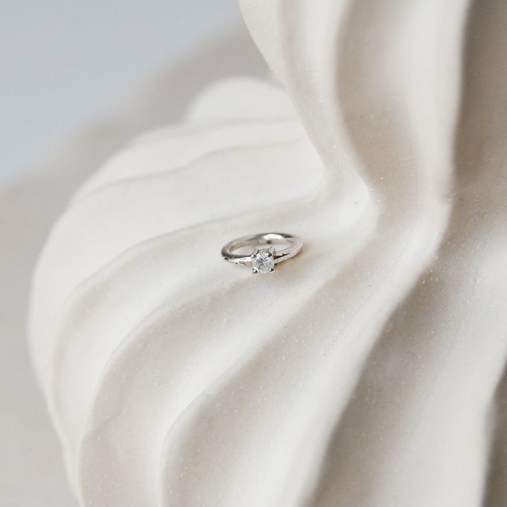 Our stunning Mini Diamond Solitaire Seamless Hoop is the must have piece for your dream ear stack! Perfect for a rook, helix and tragus piercing but it also looks great in the high lobe. Made in solid 14 karat white gold.  Diamonds are April's birthstone but also known to be a symbol of purity and absolute truth.  Sold as a single Solid 14k White Gold  This metal can be worn all day every day. It will not tarnish and can be cleaned with warm soapy water and a soft non-abrasive cloth. If wearing Everyday White Gold Diamond Cartilage Earrings, White Gold Hoop Earrings With Single Diamond For Anniversary, Anniversary White Gold Hoop Earrings With Single Diamond, Elegant Small Hoop Cartilage Earrings In White Gold, Minimalist White Gold Diamond Cartilage Earrings, Minimalist Sterling Silver Hoop Earrings With Single Diamond, Anniversary Sterling Silver Hoop Earrings With Single Diamond, Silver Hoop Earrings With Single Diamond As Gift, Minimalist Hoop Earrings With Single Diamond