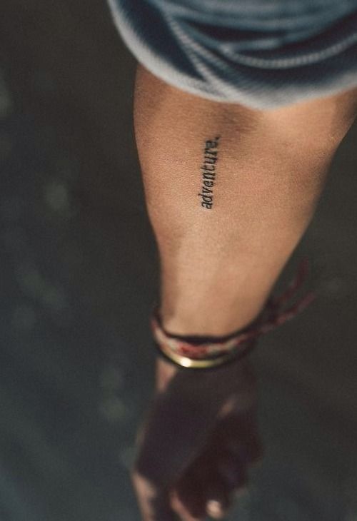 a person's foot with the word run it tattooed on their left side leg