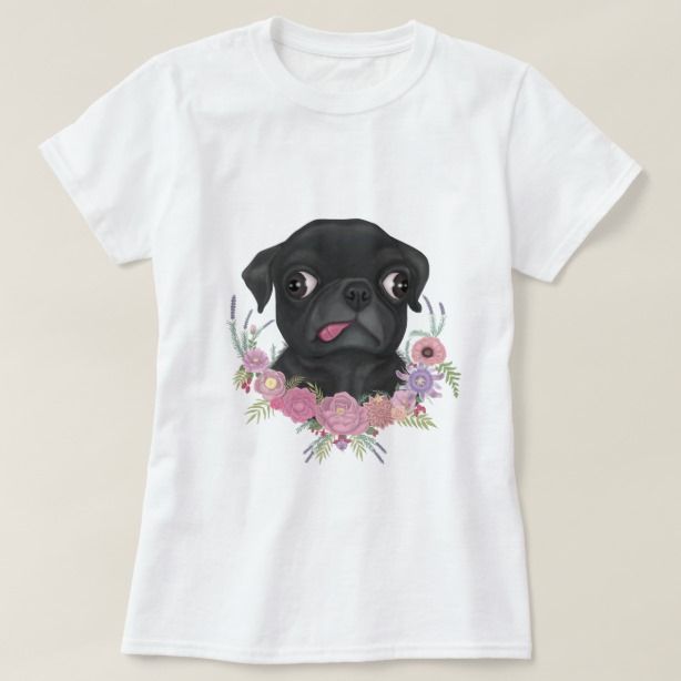 a black dog with flowers on it's chest wearing a white t - shirt