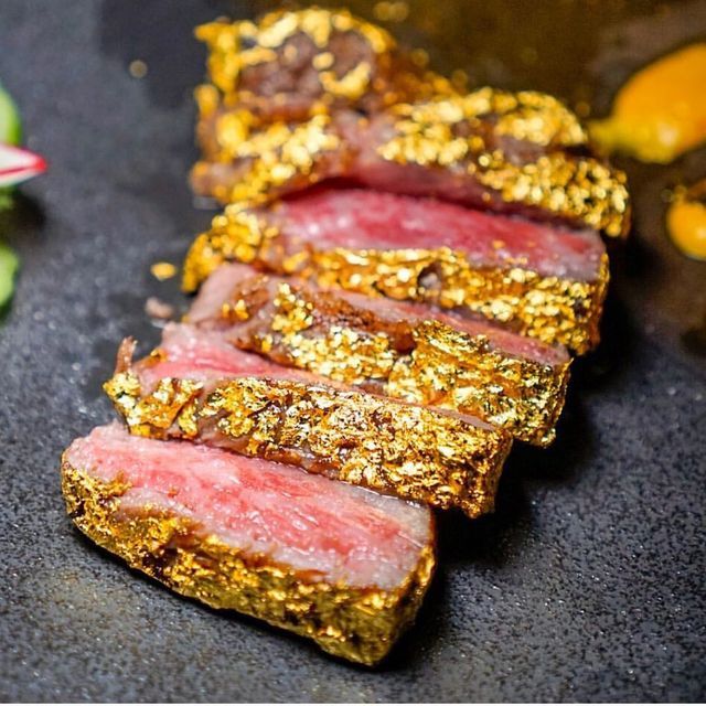 slices of meat with gold flecks on it