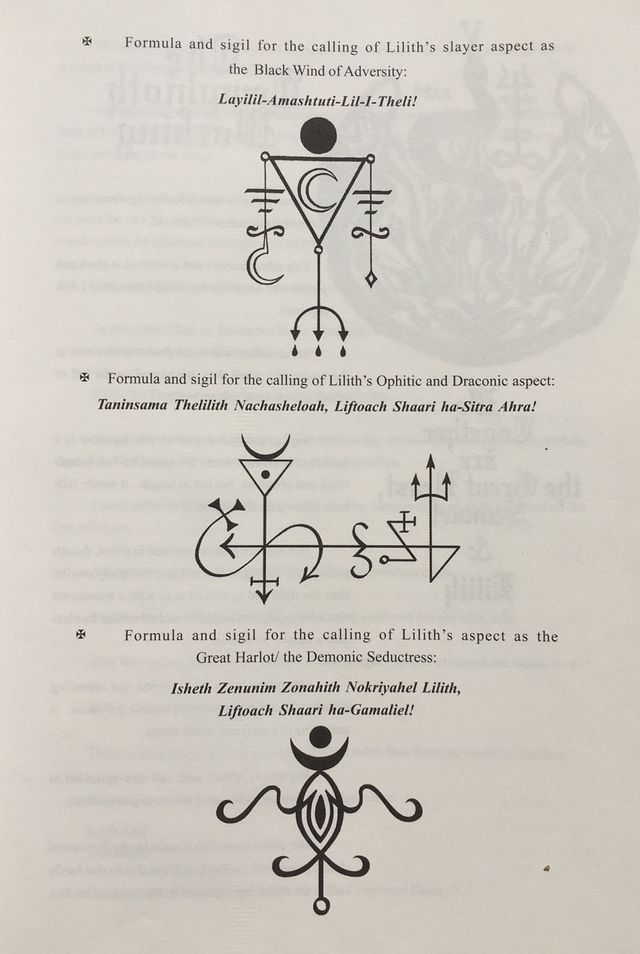 an open book with various symbols and writing on the front cover, in black ink