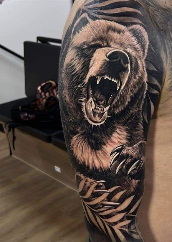 a man's arm with a bear and zebra print tattoo on the left sleeve