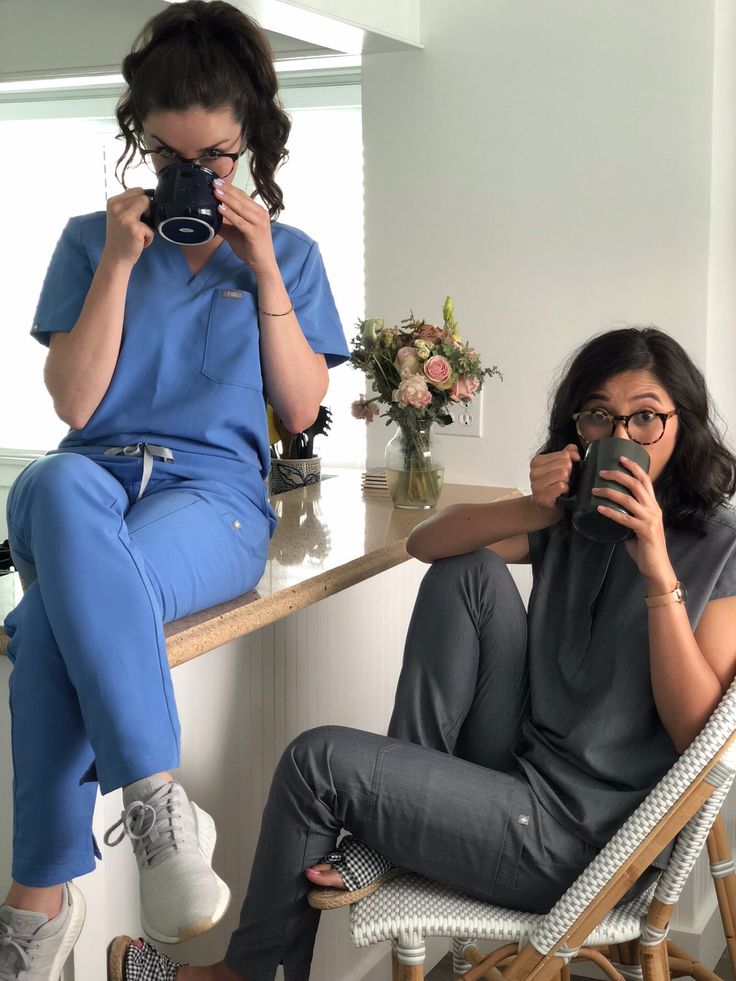 a woman taking a selfie in front of a mirror while sitting on a chair