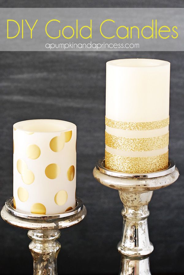 two white candles with gold polka dots on them sitting on metal stands in front of a black background