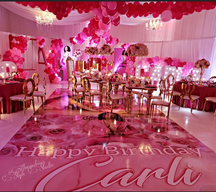 a birthday party with pink balloons and decorations on the dancefloored floor is ready for guests to arrive