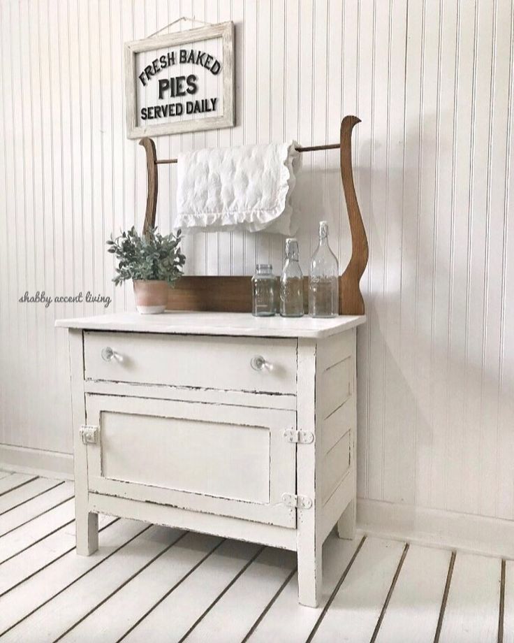 a white dresser sitting on top of a hard wood floor