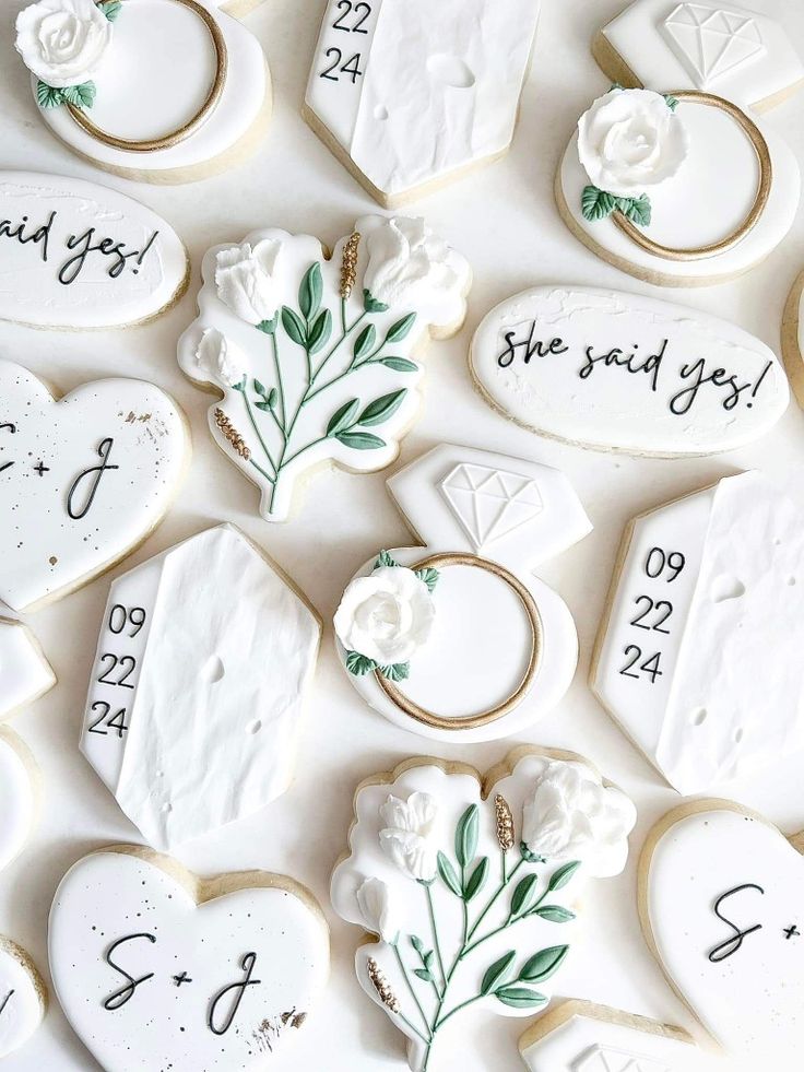 decorated cookies with wedding date and names on them are arranged in the shape of hearts