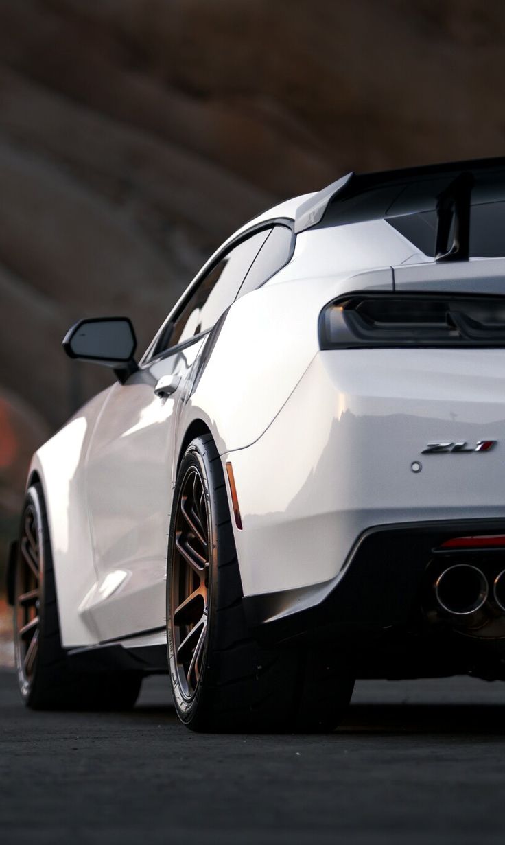 the rear end of a white sports car