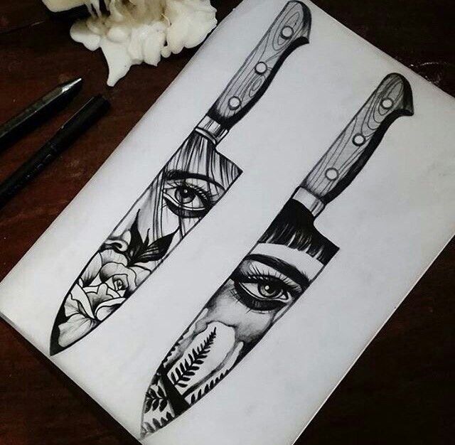 two knives with faces drawn on them next to some flowers