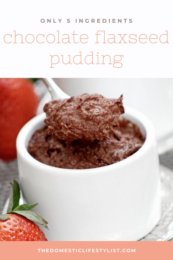 chocolate flaxseed pudding in a white bowl with strawberries on the side