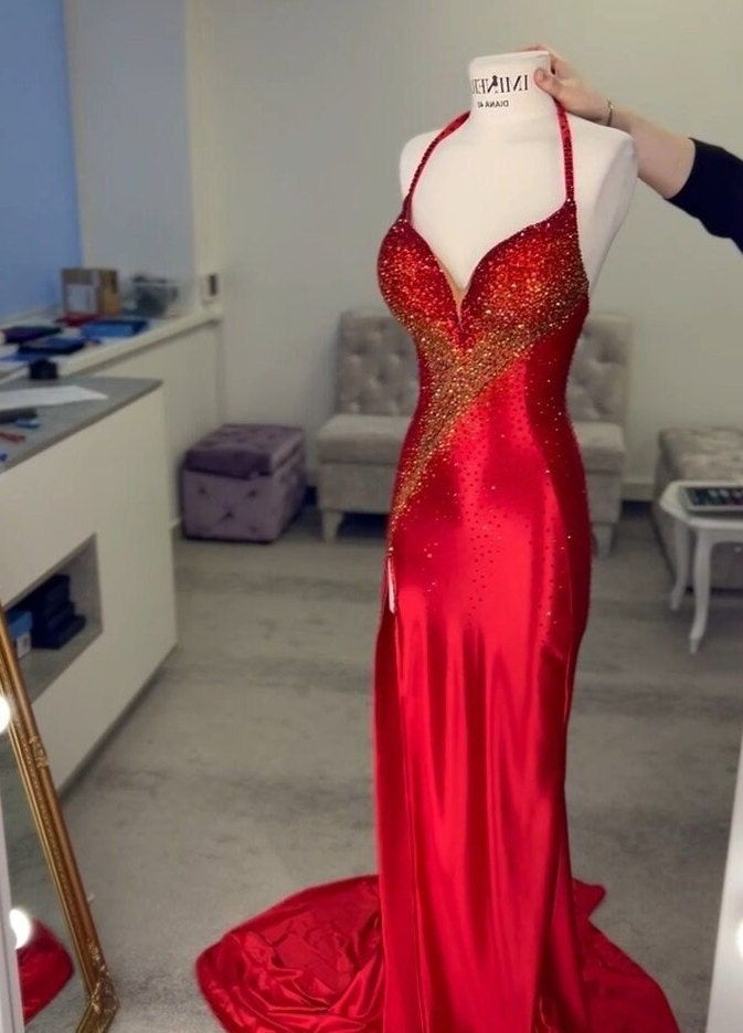 a mannequin is dressed in a red gown