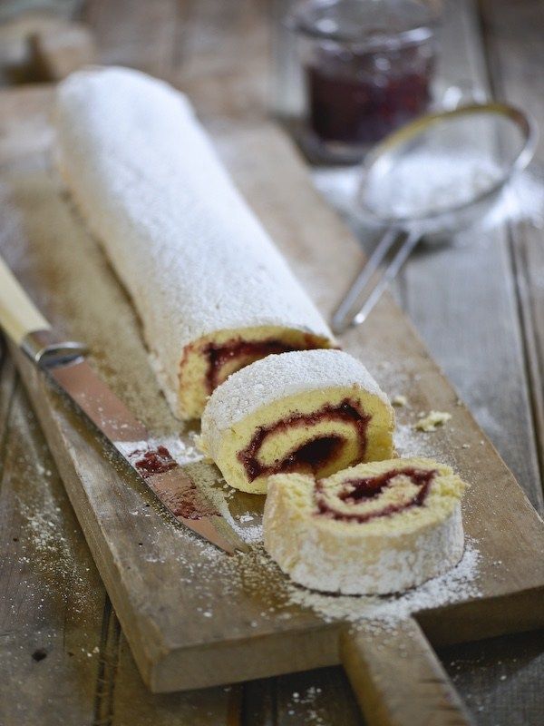 a wooden cutting board topped with pastry next to a knife