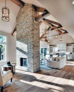 a living room filled with furniture and a fire place in the middle of a room